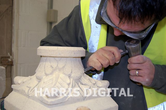 Gordon carving one of the two capitals which sit besides the relief of Moses