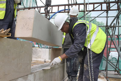 Kevin laying a bed of lime mortar ready for the stone to be lowered into position