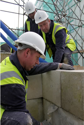 Lewis and Jim adjusting one of the stones of the second course